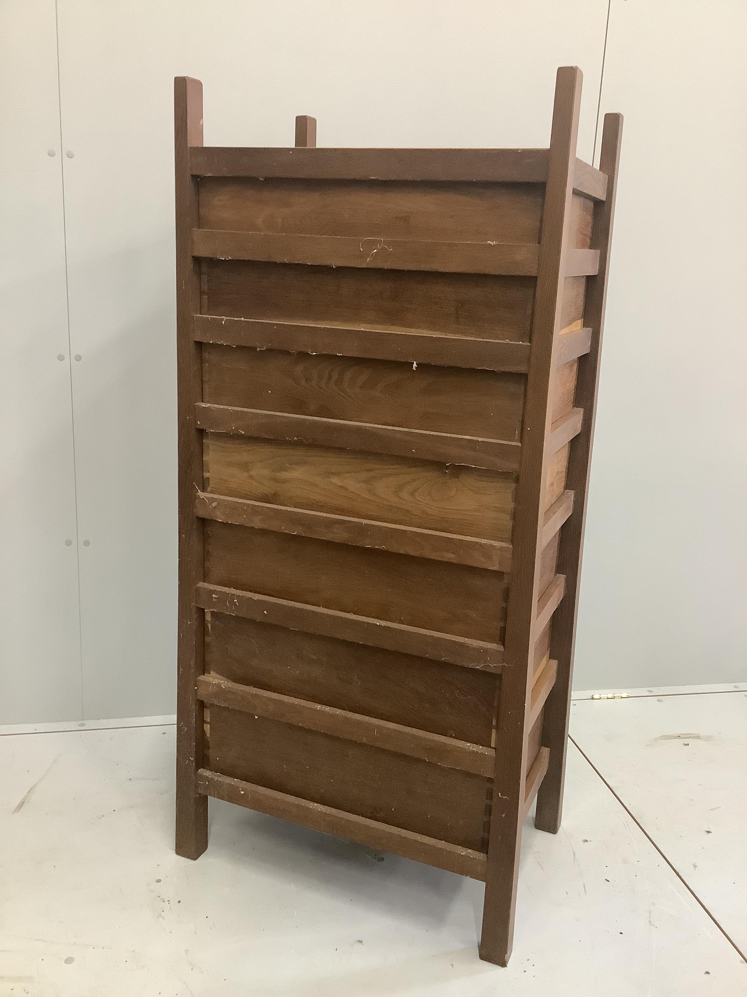 An Arts & Crafts oak seven drawer chest by Lawrence Tweedie of Derbyshire, width 67cm, height 142cm